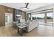 Contemporary living room with fireplace, wood paneled accent wall and large sliding glass doors at 9611 E Clinton St, Scottsdale, AZ 85260
