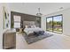 Spacious main bedroom featuring a king bed, an area rug, a modern chandelier and backyard view at 9611 E Clinton St, Scottsdale, AZ 85260