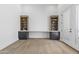 Bright office space with built-in desk, shelving, and dark cabinets for storage creating a versatile workspace at 9611 E Clinton St, Scottsdale, AZ 85260