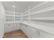Spacious pantry featuring white cabinetry and shelving with ample storage for an organized home at 9611 E Clinton St, Scottsdale, AZ 85260