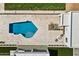 Aerial perspective of the pool and patio area featuring a fire pit and in-ground pool at 9611 E Clinton St, Scottsdale, AZ 85260