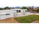 Modern home exterior with a pool, freshly laid grass, and sleek white facade at 9611 E Clinton St, Scottsdale, AZ 85260