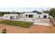 Modern home with a pool, newly installed grass, and a sleek exterior design at 9611 E Clinton St, Scottsdale, AZ 85260