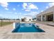 Modern swimming pool and spa featuring a water feature, set in a spacious backyard with desert landscaping at 9611 E Clinton St, Scottsdale, AZ 85260