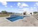 Modern swimming pool and spa featuring a water feature, set in a backyard with desert landscaping at 9611 E Clinton St, Scottsdale, AZ 85260