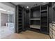 Walk-in closet leading to a bathroom with a freestanding tub and glass shower at 9611 E Clinton St, Scottsdale, AZ 85260