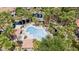 Aerial view of the community pool and surrounding lush landscaping, complemented by community lakes and nearby residences at 10015 E Mountain View Rd # 2034, Scottsdale, AZ 85258