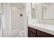 Clean bathroom features a marble counter, wood cabinets, and tiled shower and bathtub at 10015 E Mountain View Rd # 2034, Scottsdale, AZ 85258