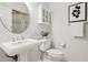 Elegant bathroom with a pedestal sink, oval mirror, and decorative artwork at 10015 E Mountain View Rd # 2034, Scottsdale, AZ 85258