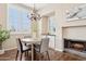 Elegant dining room featuring a chandelier, a fireplace, and large shuttered windows at 10015 E Mountain View Rd # 2034, Scottsdale, AZ 85258