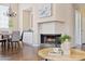 Open-concept dining and living area with a cozy fireplace and hardwood flooring at 10015 E Mountain View Rd # 2034, Scottsdale, AZ 85258