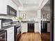 Well-lit kitchen with white cabinetry, black appliances, and a breakfast bar at 10015 E Mountain View Rd # 2034, Scottsdale, AZ 85258