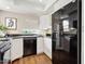 Efficient kitchen with white cabinets, dark countertops, and modern black appliances at 10015 E Mountain View Rd # 2034, Scottsdale, AZ 85258