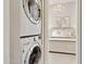 Convenient laundry area with stacked washer/dryer; bedroom view through door at 10015 E Mountain View Rd # 2034, Scottsdale, AZ 85258