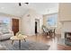 Open-concept living space with hardwood floors, a fireplace, and a seamless flow to the dining area at 10015 E Mountain View Rd # 2034, Scottsdale, AZ 85258
