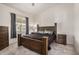 Cozy bedroom featuring wood-style flooring, dark wood furniture, and natural light from a window at 10136 E Southern Ave # 3091, Mesa, AZ 85209