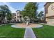 Charming community playground area with a circular layout, ideal for children to play and socialize outdoors at 10136 E Southern Ave # 3091, Mesa, AZ 85209