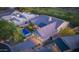 Stunning aerial view of a modern home with a pool, lush landscaping, and golf course views at dusk at 10179 E Camelot Ct, Scottsdale, AZ 85255