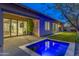 Inviting outdoor space featuring a small pool, lush landscaping, and a covered patio for relaxing evenings at 10179 E Camelot Ct, Scottsdale, AZ 85255
