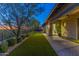 Backyard featuring a pool, artificial turf, and a desert landscape with trees and bushes at 10179 E Camelot Ct, Scottsdale, AZ 85255