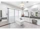Bright bathroom featuring a freestanding tub, dual vanities, and elegant finishes for a spa-like experience at 10179 E Camelot Ct, Scottsdale, AZ 85255