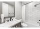 Cozy bathroom features a white vanity, framed mirror, toilet, and tiled shower at 10179 E Camelot Ct, Scottsdale, AZ 85255