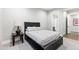 Simple bedroom featuring a dark wood bed frame and furniture along with neutral-toned walls and carpet at 10179 E Camelot Ct, Scottsdale, AZ 85255