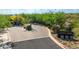 Welcoming entrance to Lane's End featuring stone pillars and lush desert landscaping at 10179 E Camelot Ct, Scottsdale, AZ 85255