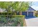 Exterior view of a modern home featuring a two-car garage, desert landscaping, and a light colored brick driveway at 10179 E Camelot Ct, Scottsdale, AZ 85255