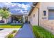 Modern home's front exterior with a neat walkway, artificial lawn, and comfortable outdoor seating at 10179 E Camelot Ct, Scottsdale, AZ 85255