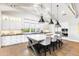 Bright, open kitchen with white cabinetry, large island with seating, and modern pendant lighting at 10179 E Camelot Ct, Scottsdale, AZ 85255