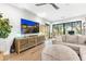 Comfortable living room featuring modern decor, a large television, and views of the outdoor landscape at 10179 E Camelot Ct, Scottsdale, AZ 85255