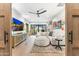 Stylish living room with a comfortable sectional sofa, modern entertainment unit, and large windows at 10179 E Camelot Ct, Scottsdale, AZ 85255