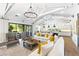 Bright living room with vaulted ceilings, hardwood floors, and open to dining area at 10179 E Camelot Ct, Scottsdale, AZ 85255