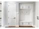 Mudroom with built-in storage, coat hooks, and a convenient bench at 10179 E Camelot Ct, Scottsdale, AZ 85255