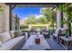 Cozy covered patio with comfortable seating and views of the beautiful backyard landscaping at 10179 E Camelot Ct, Scottsdale, AZ 85255