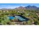 Aerial view of community pickleball courts surrounded by desert landscape and scenic mountain views at 10179 E Camelot Ct, Scottsdale, AZ 85255