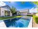 Backyard pool area with lush lawn and modern home design, perfect for outdoor relaxation and entertainment at 10179 E Camelot Ct, Scottsdale, AZ 85255