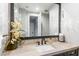 Elegant powder room with travertine countertop, modern faucet, and decorative lighting at 10179 E Camelot Ct, Scottsdale, AZ 85255