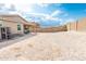 Expansive backyard with gravel and a privacy wall, ready for your personal touch and landscaping ideas at 10849 S 175Th Dr, Goodyear, AZ 85338