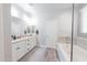 Bright bathroom with double sinks, mosaic tile accents, and separate tub and shower at 10849 S 175Th Dr, Goodyear, AZ 85338