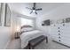 Bright bedroom featuring a ceiling fan, soft carpet, and a comfortable queen-sized bed at 10849 S 175Th Dr, Goodyear, AZ 85338