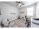 This bedroom features sleek, wood-look flooring and a modern ceiling fan, promoting a bright and airy feel at 10849 S 175Th Dr, Goodyear, AZ 85338