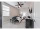 Well-lit bedroom featuring a ceiling fan, soft carpet, and a comfortable queen-sized bed at 10849 S 175Th Dr, Goodyear, AZ 85338