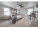 Calming bedroom featuring plush carpet, ceiling fan, and neutral gray accents at 10849 S 175Th Dr, Goodyear, AZ 85338