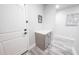 Inviting entryway with stylish gray cabinet, modern door hardware, and wood-look flooring at 10849 S 175Th Dr, Goodyear, AZ 85338