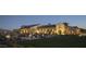 Stunning exterior view of the community center at dusk, with manicured lawns and elegant lighting, a great event venue at 10849 S 175Th Dr, Goodyear, AZ 85338