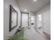 Inviting hallway with hardwood floors and neutral colors, leading to various rooms at 10849 S 175Th Dr, Goodyear, AZ 85338