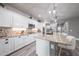 Bright kitchen with white cabinets, granite countertops, stainless steel appliances and spacious island at 10849 S 175Th Dr, Goodyear, AZ 85338
