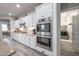 Bright kitchen features white cabinetry, stainless steel appliances, granite countertops and luxury vinyl plank flooring at 10849 S 175Th Dr, Goodyear, AZ 85338